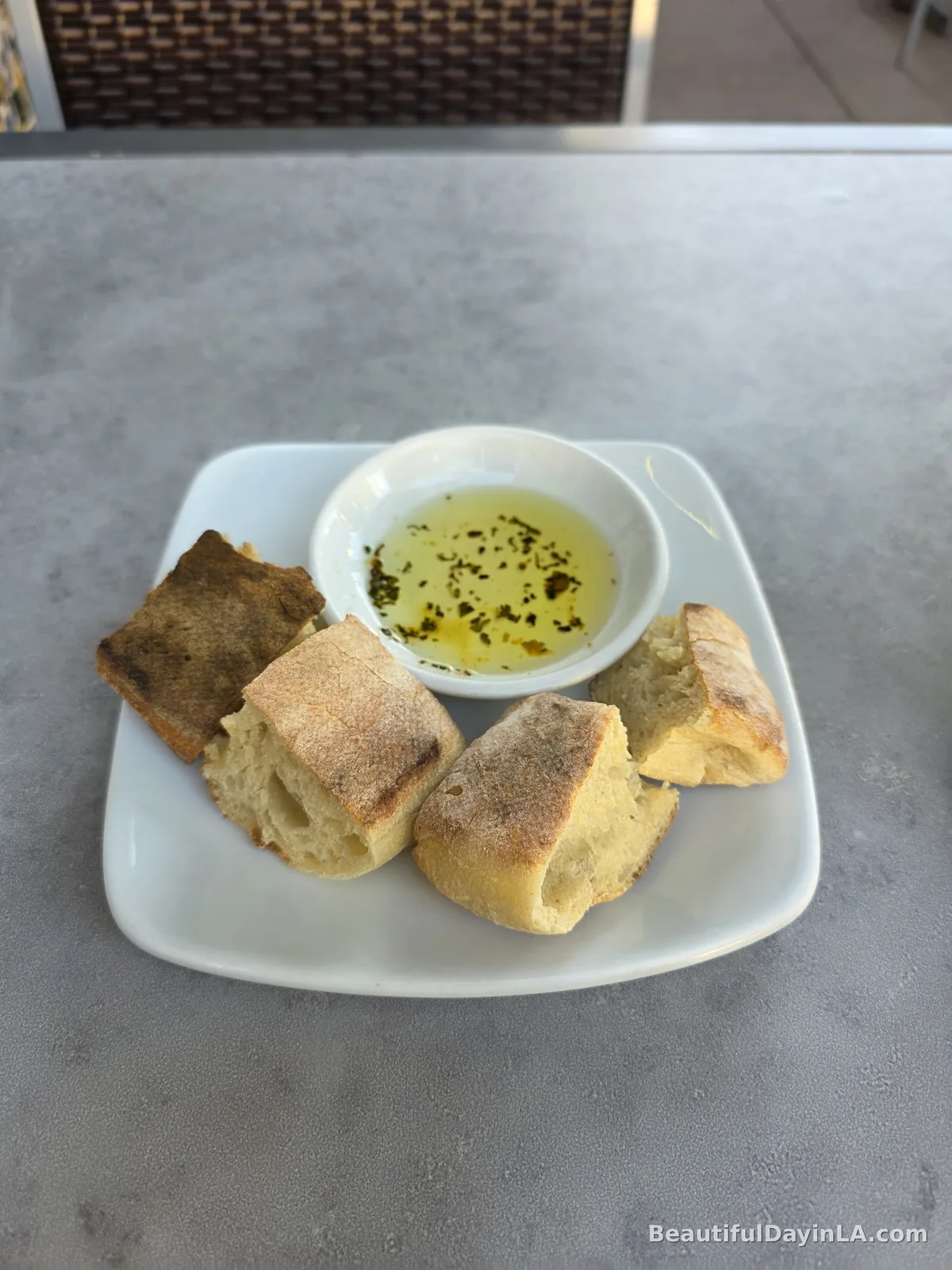 Complimentary bread served with a dish of seasoned olive oil at California Pizza Kitchen