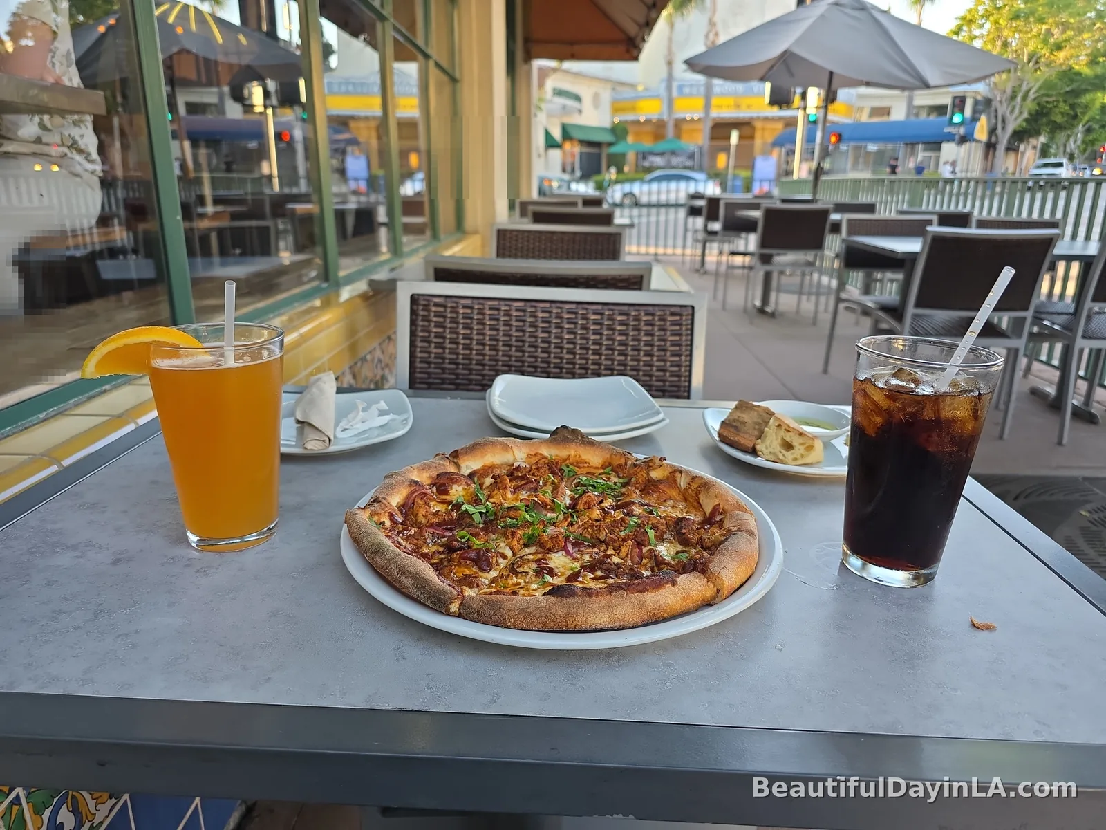 Outdoor patio seating at California Pizza Kitchen in Westwood Village in the evening